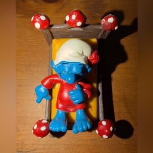 Vintage Schleich Super Smurf figurine titled "Smurf in Bed"